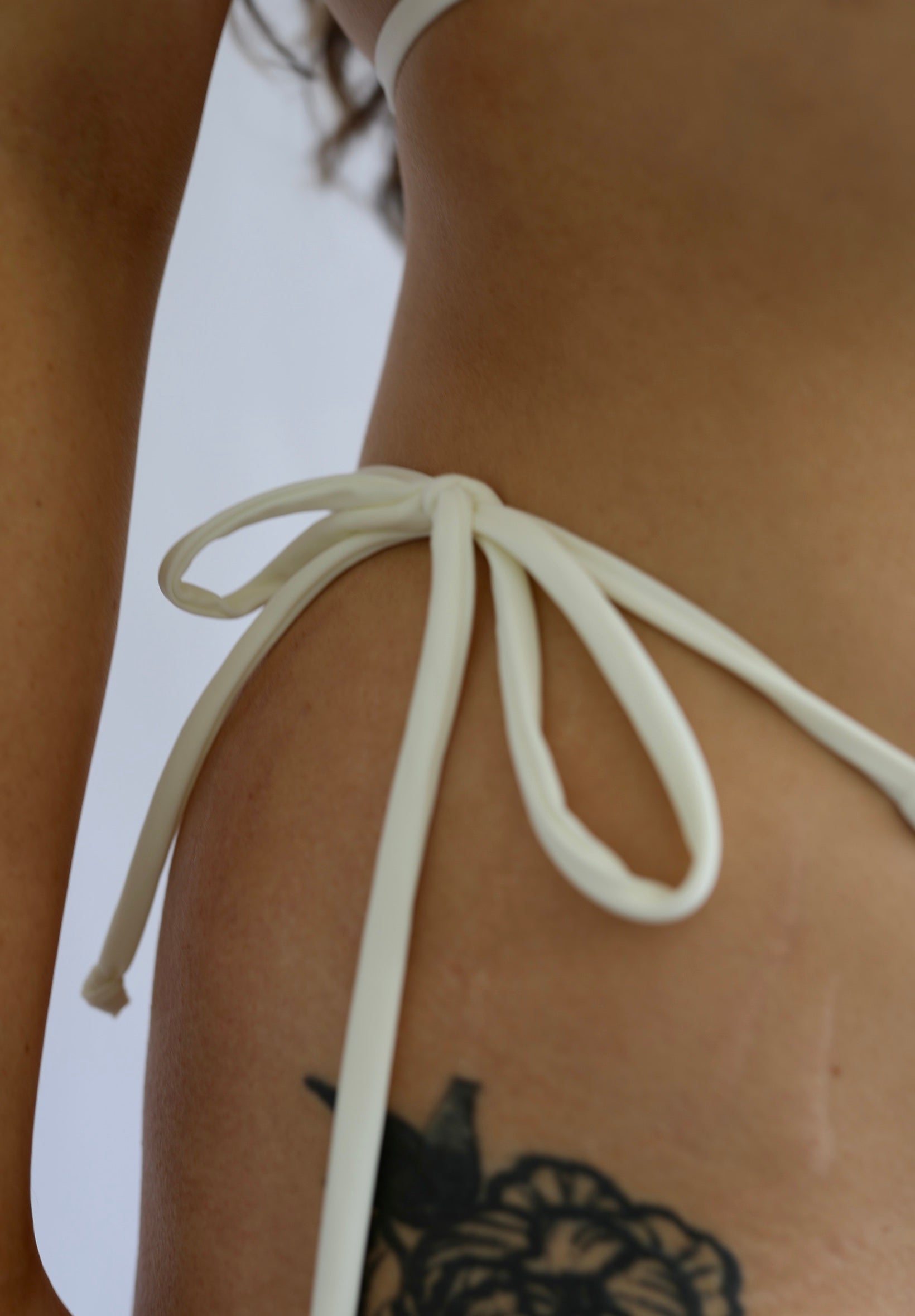 Close-up of an ivory tie-side bikini bottom