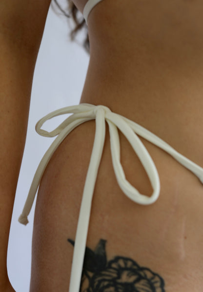 Close-up of an ivory tie-side bikini bottom